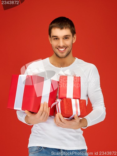 Image of man holding many gift boxes