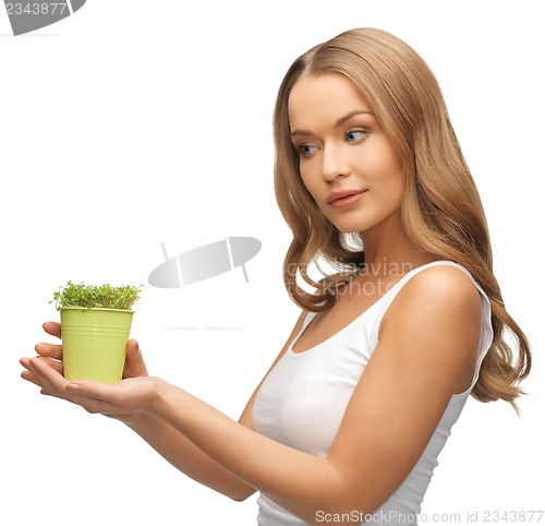 Image of woman with green grass in pot