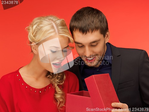 Image of man and woman looking inside the gift box