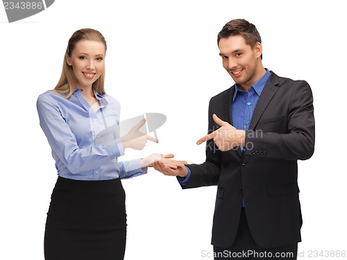 Image of man and woman making a gun gesture