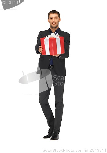 Image of handsome man in suit with a gift box