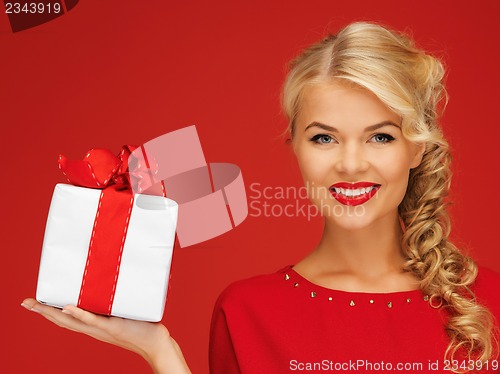 Image of lovely woman in red dress with present