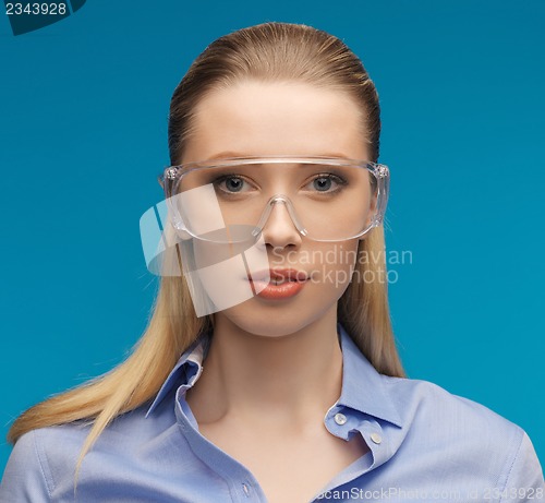 Image of businesswoman in protective glasses