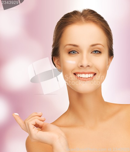 Image of beautiful woman with moisturizing creme drop