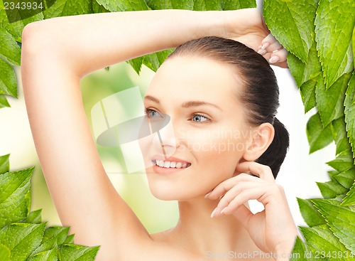 Image of beautiful woman with green leaves