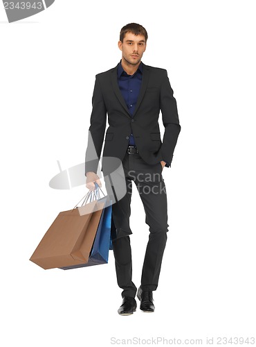 Image of handsome man in suit with shopping bags