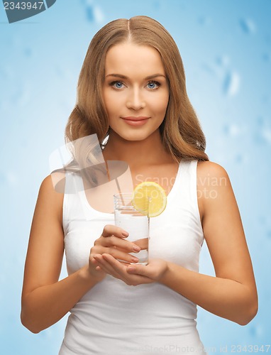 Image of woman with lemon slice on glass of water