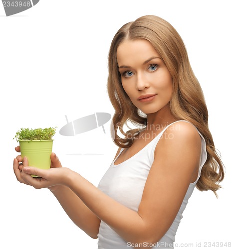 Image of woman with green grass in pot