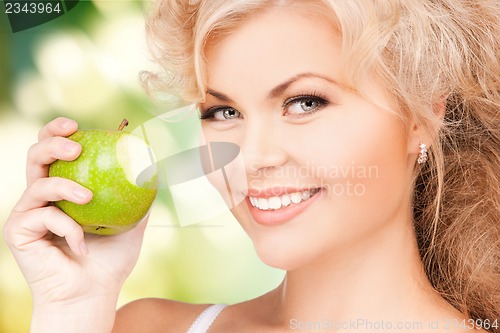 Image of young beautiful woman with green apple