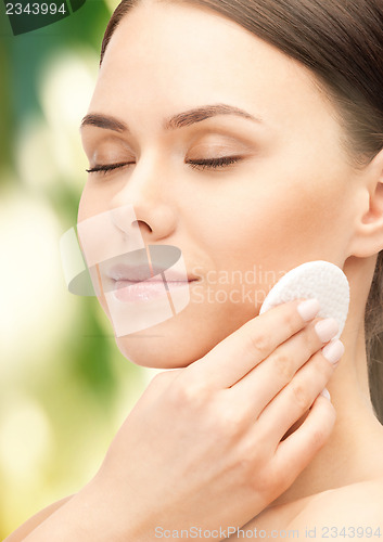 Image of beautiful woman with cotton pad