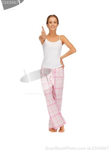 Image of woman in cotton pajamas showing thumbs up