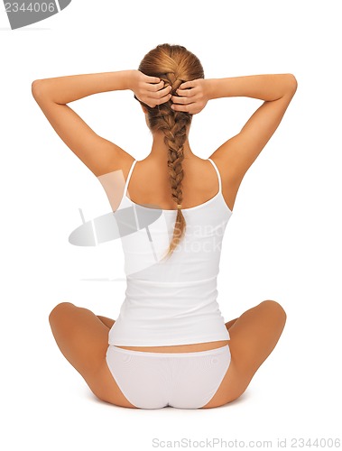 Image of woman in undrewear practicing yoga lotus pose