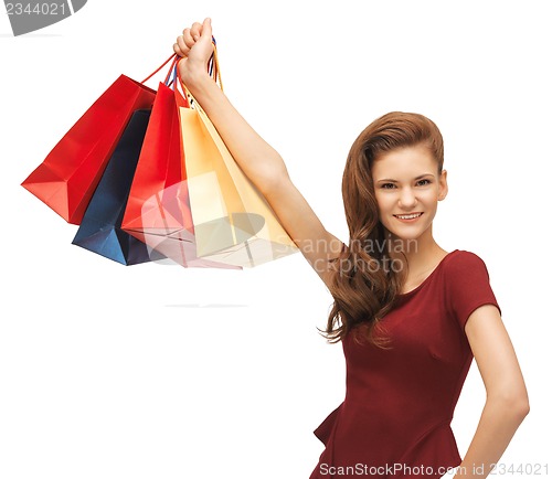 Image of happy teenage girl with shopping bags