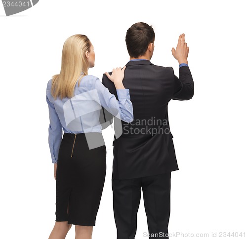 Image of man and woman working with something imaginary