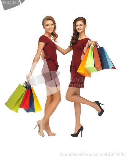 Image of teenage girls in red dresses with shopping bags