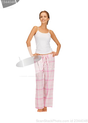 Image of happy and smiling woman in cotton pajamas