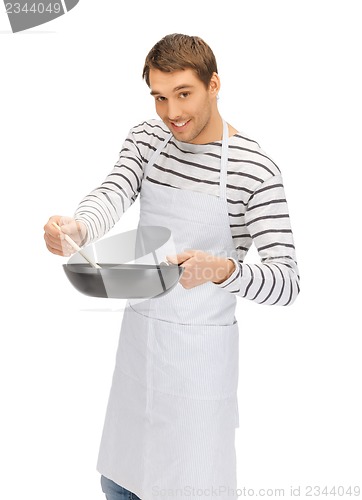 Image of handsome man with pan and spoon