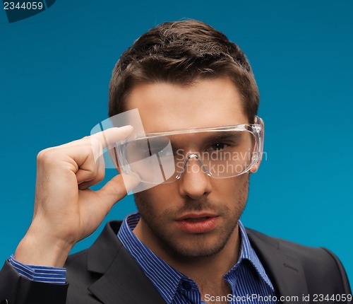 Image of businessman in protective glasses