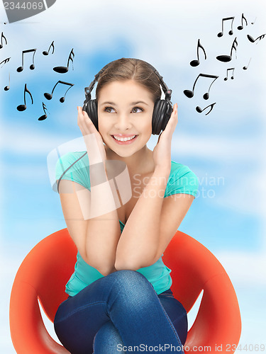 Image of happy teenage girl in big headphones