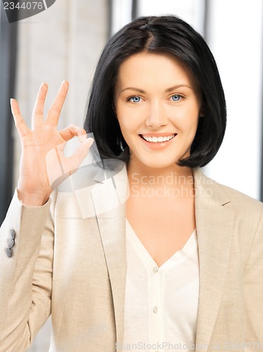 Image of young woman showing ok sign