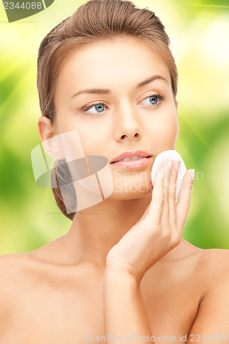 Image of beautiful woman with cotton pad