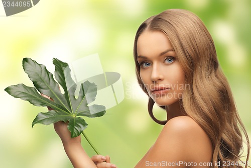 Image of woman with green leaf