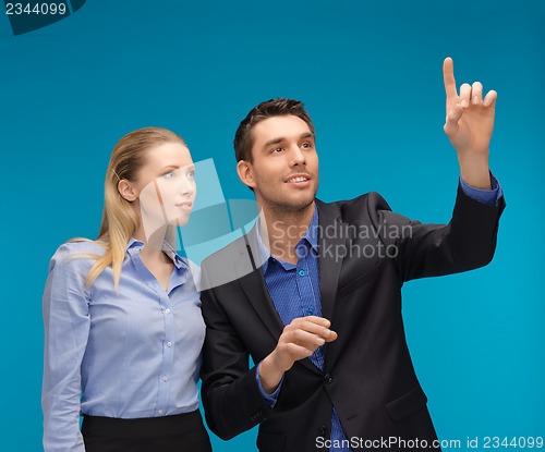 Image of man and woman working with something imaginary