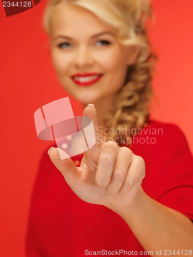 Image of woman in red dress pressing virtual button