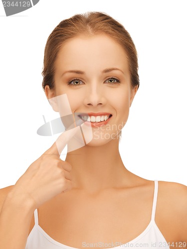Image of beautiful woman pointing to teeth