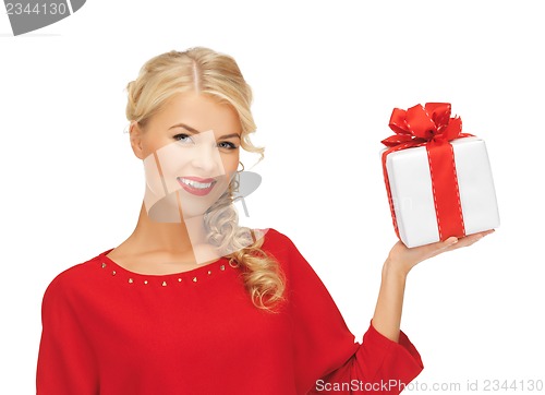 Image of lovely woman in red dress with present