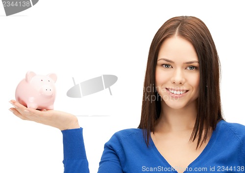 Image of lovely woman with piggy bank