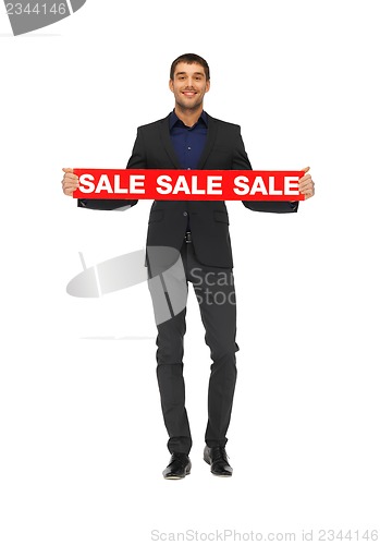 Image of handsome man in suit with sale sign