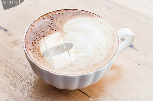 Image of Free pour hot coffee latte art cup on wood background