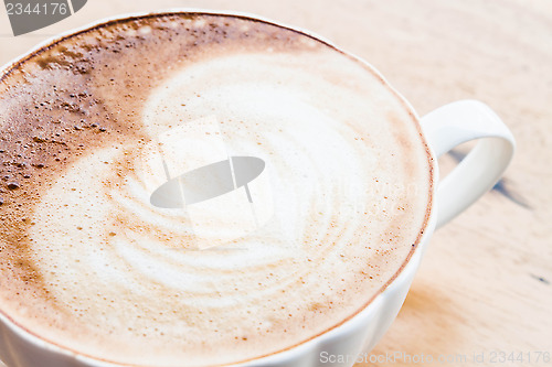 Image of Free pour hot coffee latte art cup up close