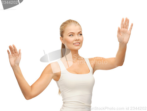 Image of woman in white t-shirt pressing imaginary button