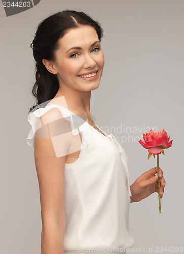 Image of young and beautiful woman with flower