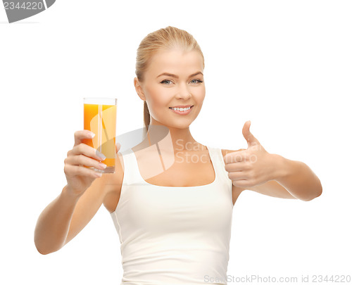 Image of woman holding glass of orange juice