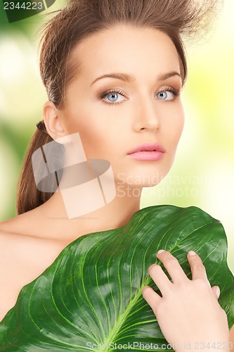 Image of woman with green leaf