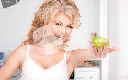 Image of young beautiful woman with green apple