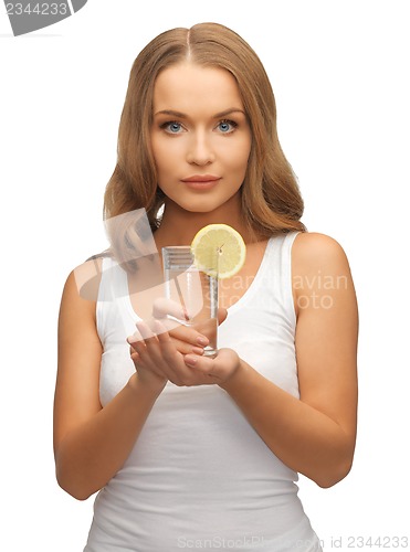 Image of woman with lemon slice on glass of water