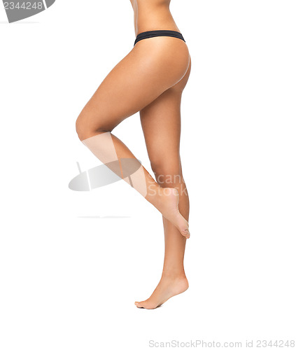 Image of female legs in black bikini panties
