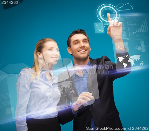 Image of man and woman working with virtual touch screens