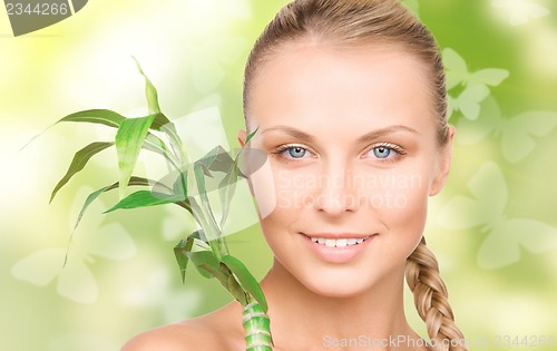 Image of woman with sprout and butterflies