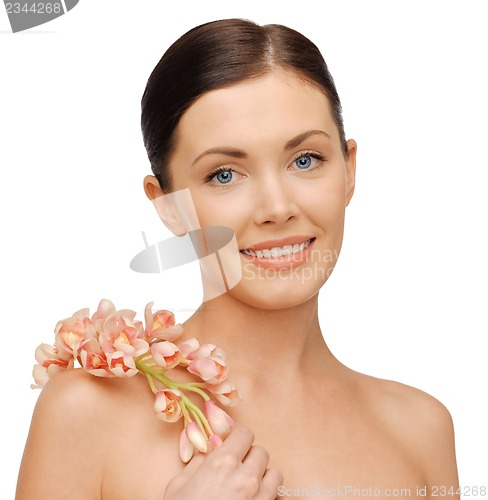 Image of lovely woman with orchid flower