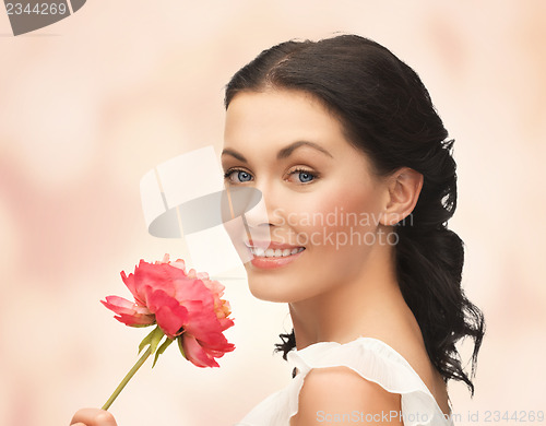 Image of young and beautiful woman with flower