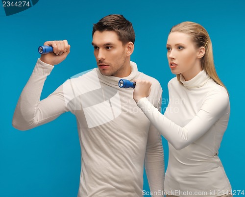 Image of man and woman with pocket flashlights