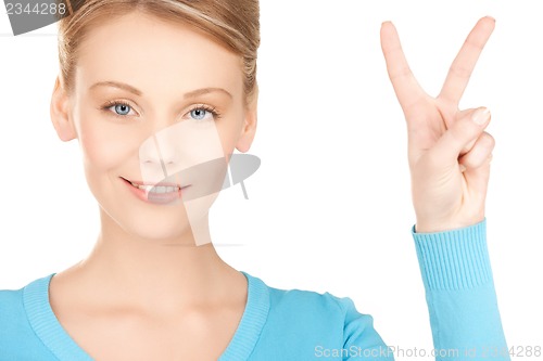 Image of young woman showing victory or peace sign