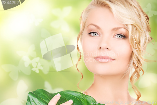 Image of woman with green leaf and butterflies