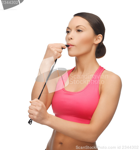 Image of woman with whistle looking at something