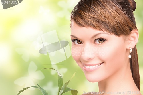 Image of woman with sprout and butterflies